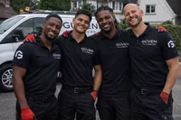 Güven Plumbers in branded workwear beside a company van